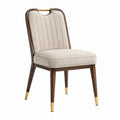 Silla de madera y tela beige con detalles dorados